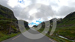 Norway road including bends and crossing mountains in remote landscape in HDR, HFR