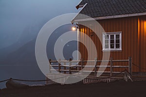 Norway rorbu houses and mountains rocks over fjord landscape scandinavian travel view Lofoten islands. Night landscape.