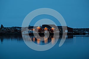 Norway rorbu houses and mountains rocks over fjord landscape scandinavian travel view Lofoten islands. Night landscape.