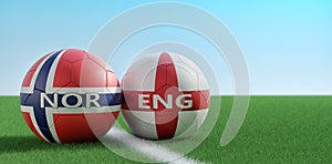 Norway vs. England Soccer Match - Soccer balls in Norways and Englands national colors on a soccer field. photo