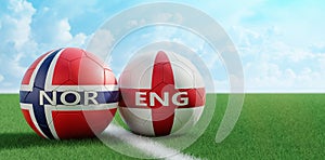 Norway vs. England Soccer Match - Soccer balls in Norways and Englands national colors on a soccer field. photo