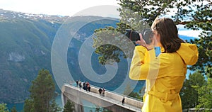 Norway. Young Adult Caucasian Woman Lady Tourist Traveler Photographer Taking Pictures Photos Near Stegastein Viewpoint