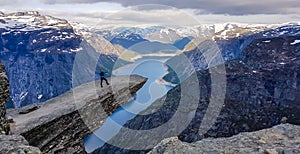 Norway - Young man standing at the edge of Trolltunga