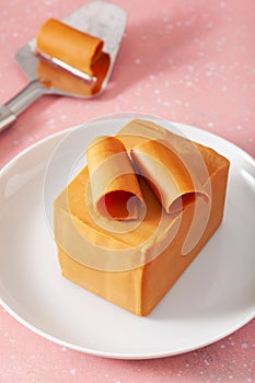Norwegian brunost traditional brown cheese block and slicer