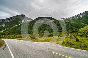 Norwegian country road in the summer amoung the mountains.