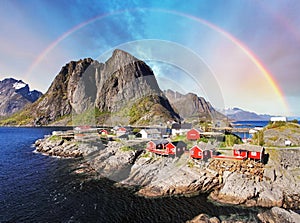 Norwegian fishing village huts with rainbow, Reine, Lofoten Islands, Norway photo