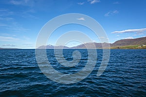 Norwegian fjord landscape with mountains and blue sky in summer