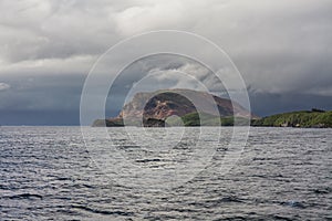 Norwegian fjord and mountains surrounded by clouds, ideal fjord reflection in clear water. selective focus