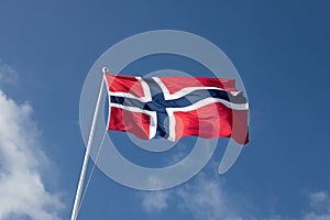 Norwegian flag flapping in clear blue sky