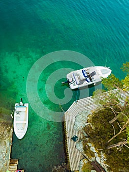 Norwegian hytte and boats on fjord shore, aerial view photo