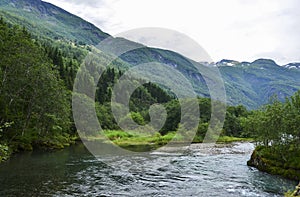 Norwegian landscape with mountain pure cold water river and fjords on background, Norway