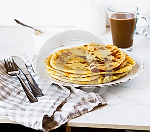 Norwegian potato pancakes Lefse in a white plate on table.