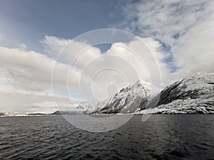 Norwegian sailing trollfjord and coast during a winter sail with snow