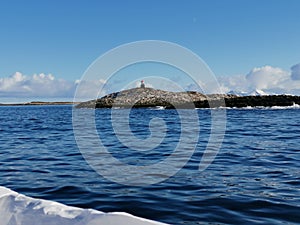 Norwegian sailing trollfjord and coast during a winter sail with snow