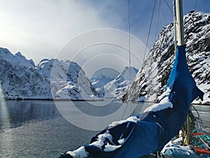 Norwegian sailing trollfjord and coast during a winter sail with snow