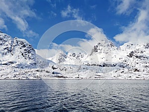 Norwegian sailing trollfjord and coast during a winter sail with snow