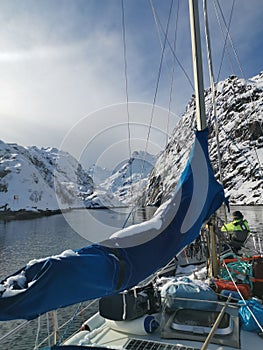 Norwegian sailing trollfjord and coast during a winter sail with snow