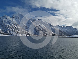 Norwegian sailing trollfjord and coast during a winter sail with snow