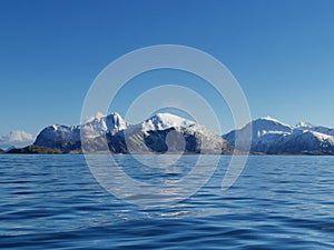 Norwegian sailing trollfjord and coast during a winter sail with snow