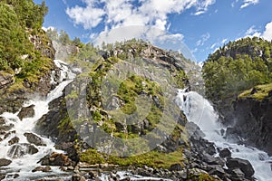 Norwegian twin waterfall. Rocky forest landscape. Latefossen. Vi