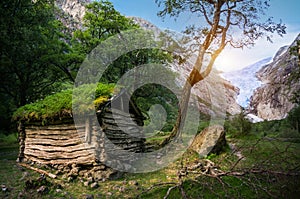 Norwegian typical grass roof wooden old house in glacier panorama