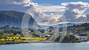 Norwegian village in fjord landscape on sunny day