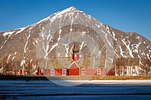 Norwegian wooden red church before mountain
