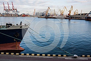 nose of cargo ship with industrial port background