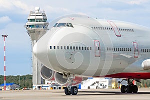 Nose cockpit pilot of airplane on the runway at the airport atc tower.