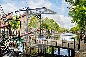 The nose of an old tjalk and a drawbridge across a canal in Schiedam, Netherlands.