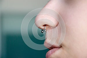 Nose Piercing septum. side view with copy space for text