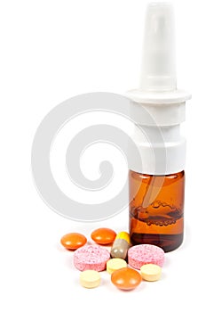 Nose spray and varicoloured pills