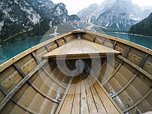 Nose of wooden boat at the alpine mountain lake. Lago di Braies, Dolomites Alps, Italy.