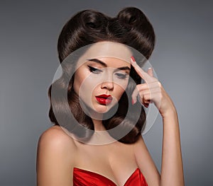 Nostalgia. Pin up girl with red lips makeup and retro curls hair photo