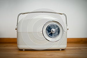 Nostalgic classic old fashioned transistor radio set with wireless tuning dial on table receiving shortwave tuner broadcast