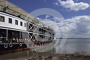 A nostalgic colonial-style ship is anchored on the banks of the Mekong photo