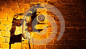 Nostalgic Echo: Old Telephone on a Rustic Brick Background