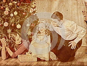 Nostalgy Christmas family with child girl dressing Christmas tree. photo