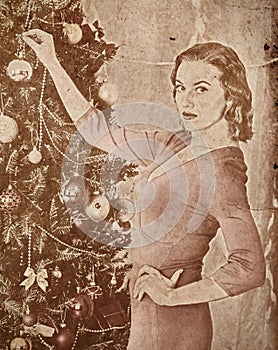 Nostalgy Christmas woman dressing Xmas tree.