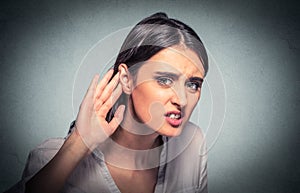 Nosy woman hand to ear carefully listens in on gossip conversation. Hard to hear