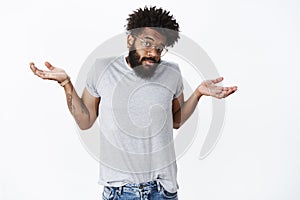 So, not big deal. Portrait of confused and questioned unaware funny african american man shrugging with puzzled look and