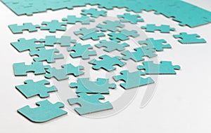 Not fully assembled puzzle in blue on a light background