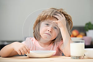 Not hungry. Kid refusing to eat. Child have no appetite. Upset little kid refuse to eat organic cereals with milk. Child