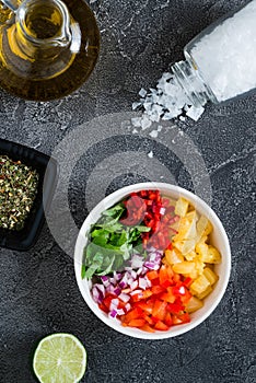 Not mixed pineapple salsa with chili, onion, mint. Top view photo