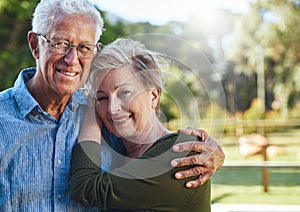 Not older, just wiser. Portrait of a mature couple posing together in their backyard.