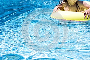Not recognizable toddler child in a swimming pool