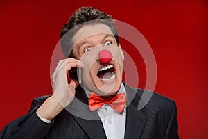 He is not taken seriously. Portrait of angry man with a clown no