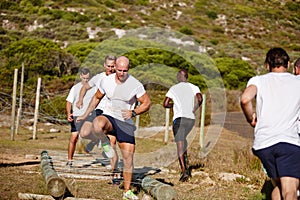 This is not the time for slacking. a group of men doing drills at a military bootcamp.