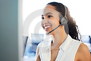 Not to worry, Im here to help. an attractive young call centre agent sitting alone in the office and using her computer.