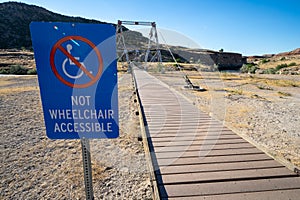 Not Wheelchair Accessible sign on the boardwalk trail area leading to the swinging bridge in Hot Springs State Park in Thermopolis